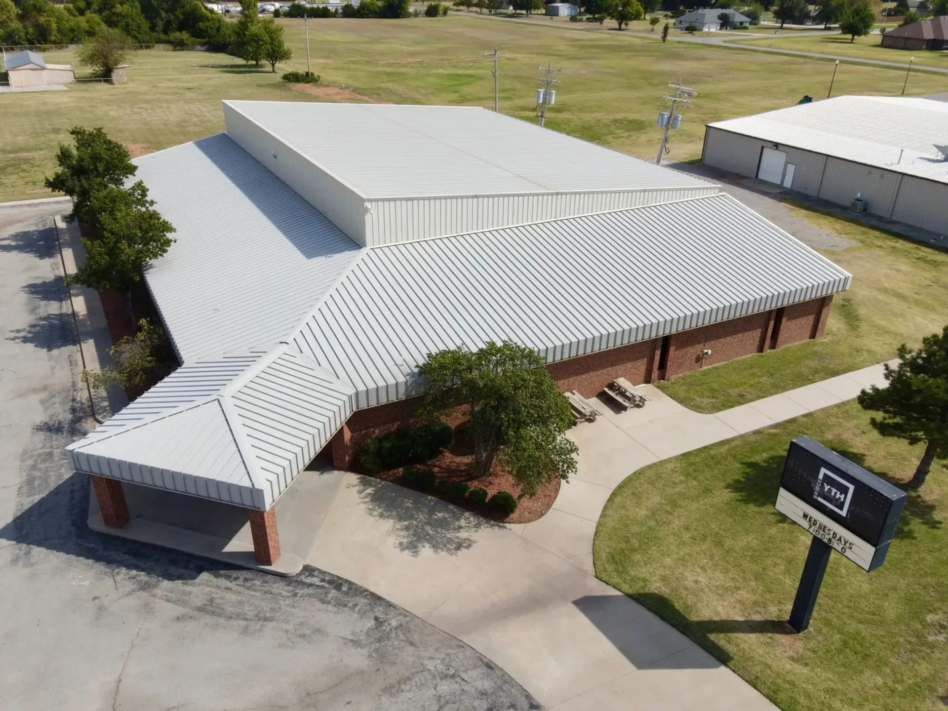 An aerial view of a building with a large roof.